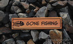 Gone fishing sign macrocarpa with fish bone carving on left hand side 500 x 140